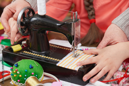 mother teaching daughter girl sew, job training, handmade and handicraft concept