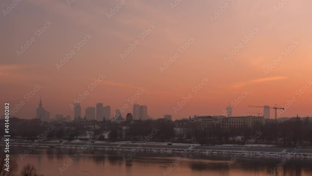 A beautiful timelapse of the sunset. An European modern big city is in the background. River flows. A beautiful timelapse of the sunset. An European modern big city is in the background. River flows.