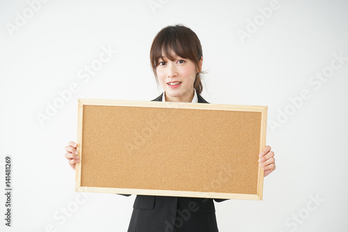Young business woman holding board
