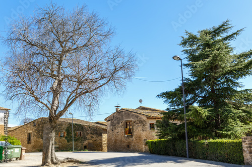 View of the square with the stone houses of the 16th century. Village Sant-Esteve-de-Guialbes (San Esteban de Guialbes), province Girona, Spain photo