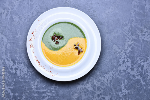 spinach and pumpkin cream soup or puree in infinity sign