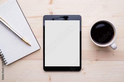 Digital tablet with blank screen and coffee