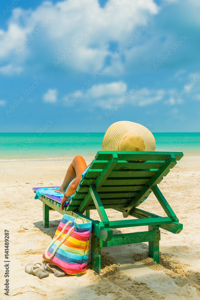 Woman on a deck chair at the beach Woman on a deck chair at the beach