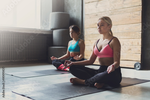 Young women in yoga class, relax meditation pose