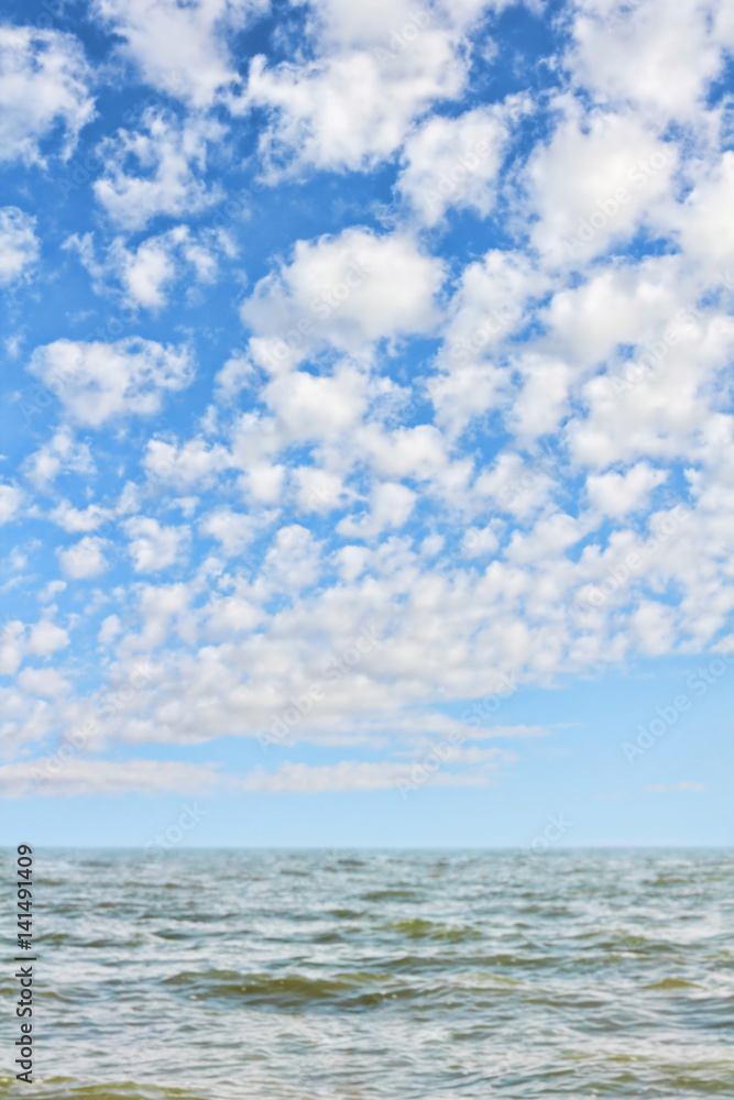 Picturesque seascape.Sea waves and blue cloudy sky.