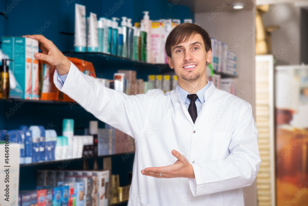 Male pharmacist posing in drugstore