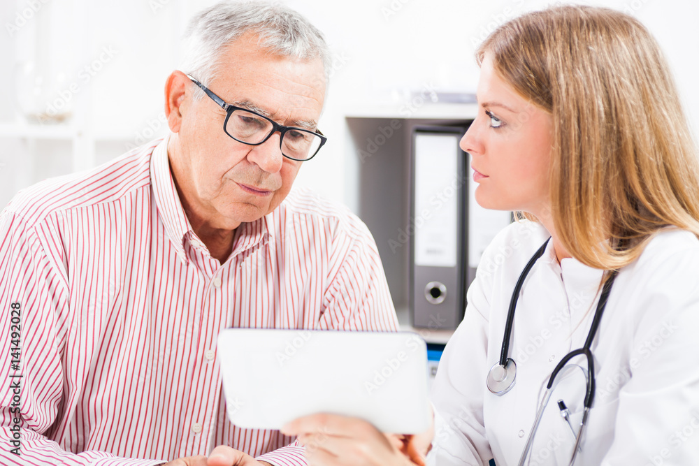 Doctor is showing medical test results to her patient. Doctor is showing medical test results to her patient.