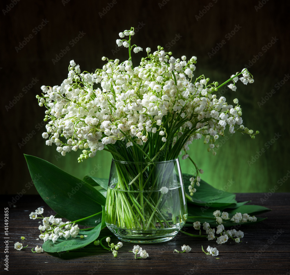 Lily of the valley bouquet on the wooden table.