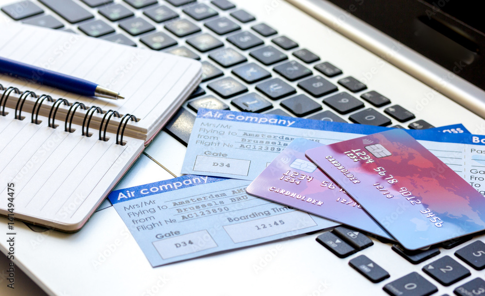 travel concept with credit cards and flight tickets on laptop travel concept with credit cards and flight tickets on laptop