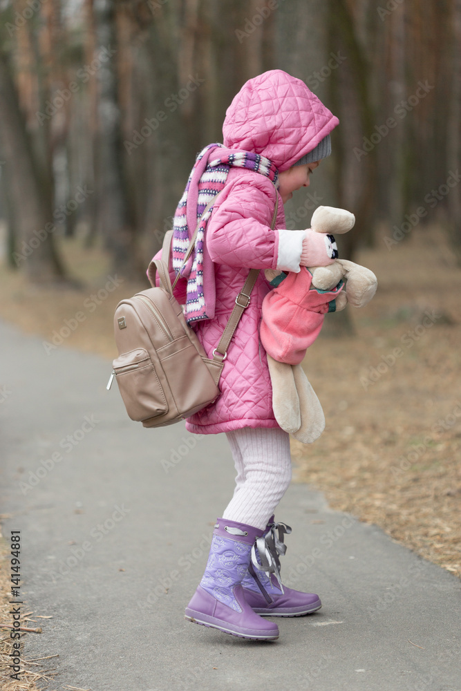 Fototapeta premium Little girl dropped the doll on a walk