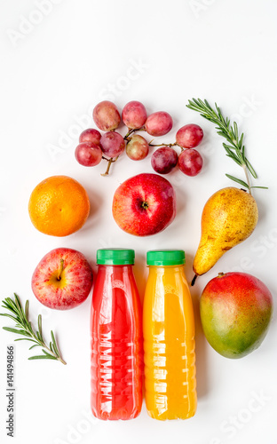 plastic bottles with fruit drinks on white background top view mock-up