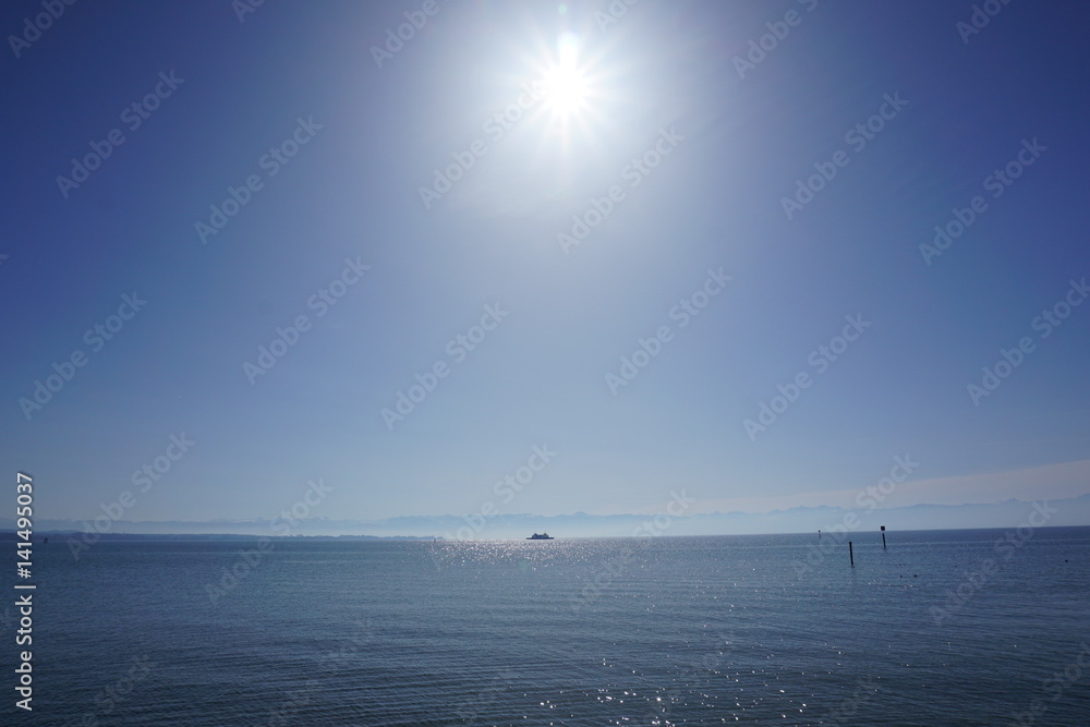 view of the lake with ship and sun