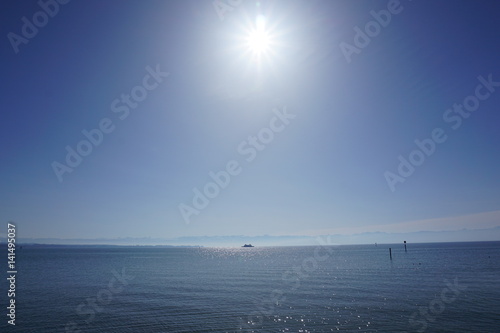 view of the lake with ship and sun