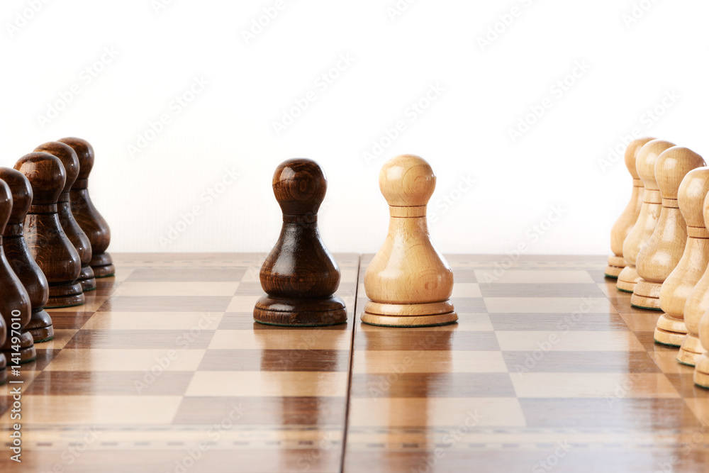 Black and white chessmen on chessboard Black and white chessmen on chessboard