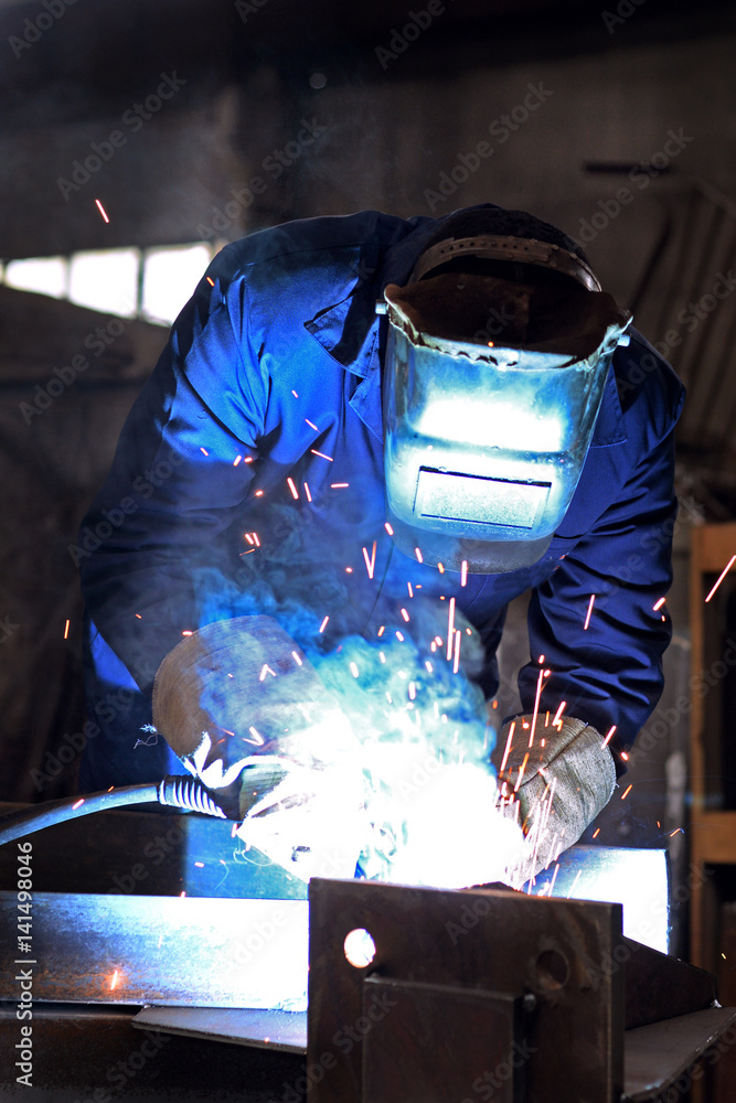 Welders working at the factory made metal Welders working at the factory made metal