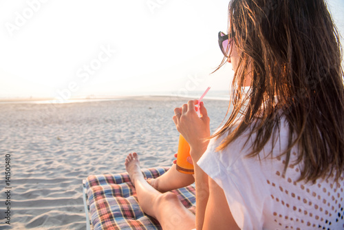 woman drink juice on beach