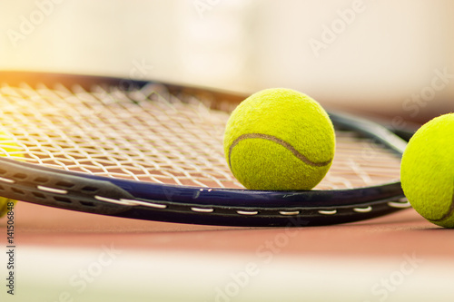 Tennis Ball with Racket on the racket in tennis court © smolaw11