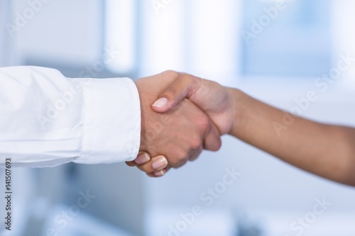 Close-up of doctor and patient shaking hands