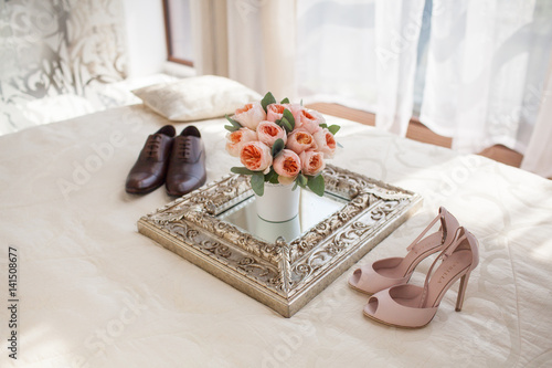 Wedding decorating bouquet with newlyweds shoes