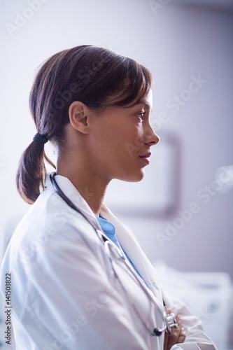 Thoughtful female doctor with stethoscope in ward