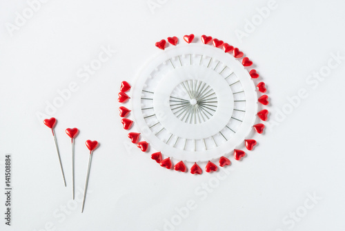 Heart shaped pins on white background