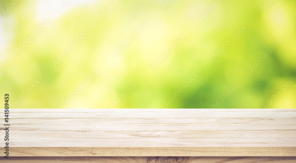 Empty wood table top on blur abstract green garden in the morning.For montage product display or key visual layout Empty wood table top on blur abstract green garden in the morning.For montage product display or key visual layout