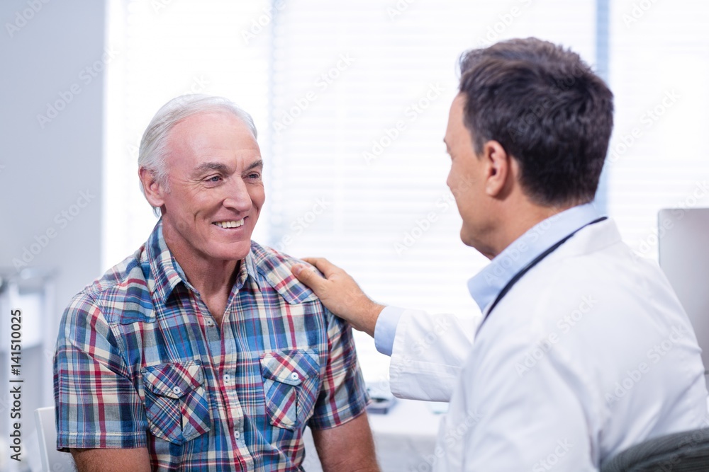 Doctor consoling senior man Doctor consoling senior man