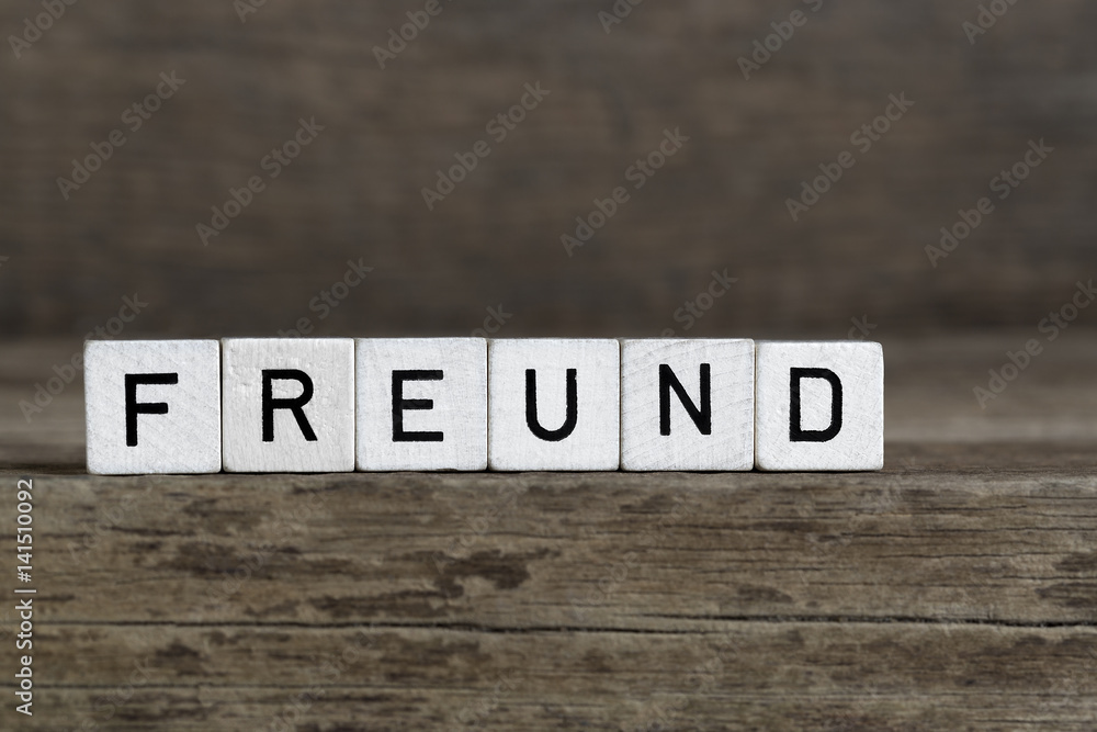 Fototapeta premium German word friend, written in cubes