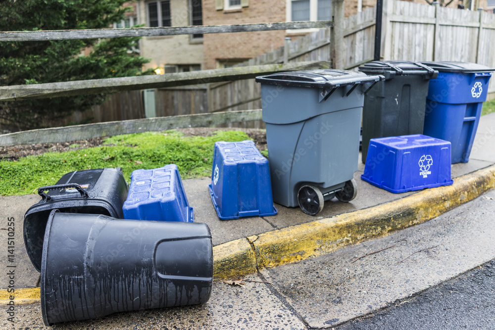 Trash cans outside on curb with recycle bins in neighborhood Trash cans outside on curb with recycle bins in neighborhood