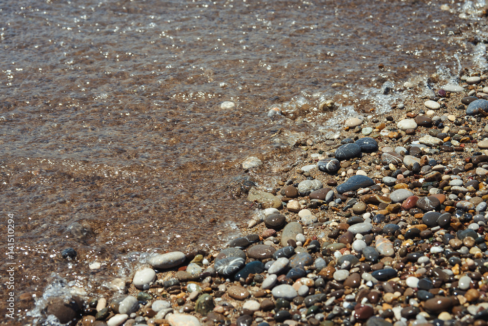 Close up of a pebble beach with the sea.
