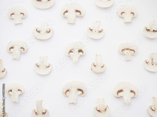 Background pattern with mushrooms. Champignons on a white background. Abstract background with food.
