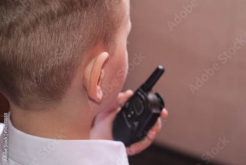 a boy with a walkie-talkie