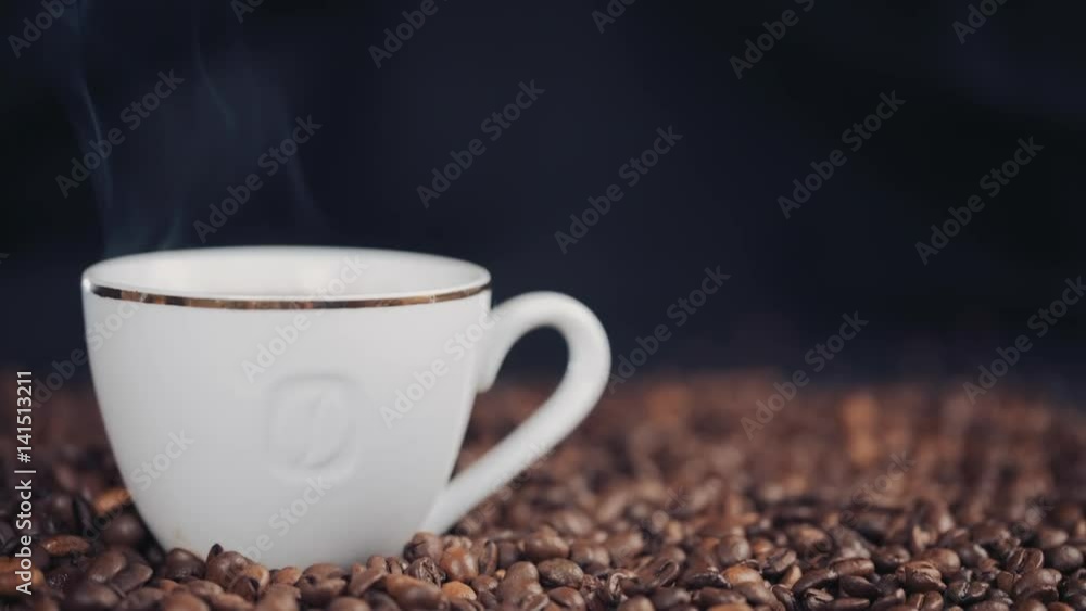 cup with hot drink on roasted coffee beans. Slow motion. cup with hot drink on roasted coffee beans. Slow motion.