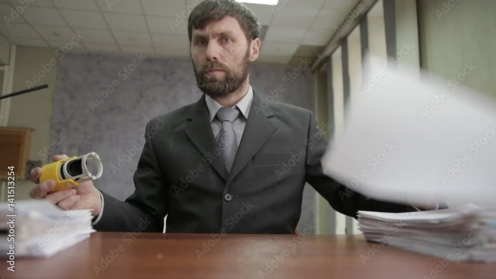 Busy office worker stamping incoming documents. businessman scatter documents around. Busy office worker stamping incoming documents. businessman scatter documents around.