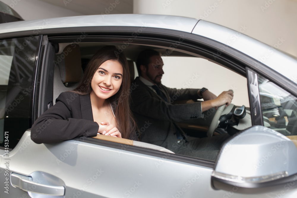 couple chooses the car in the showroom couple chooses the car in the showroom