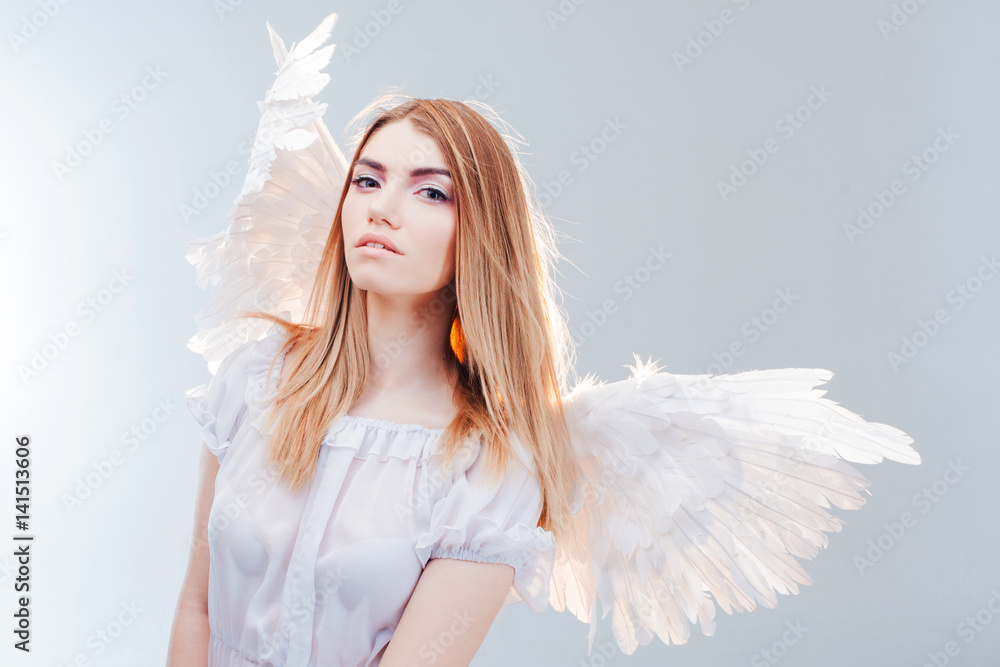 An angel from heaven. Young, wonderful blonde girl in the image of an angel with white wings. An angel from heaven. Young, wonderful blonde girl in the image of an angel with white wings.
