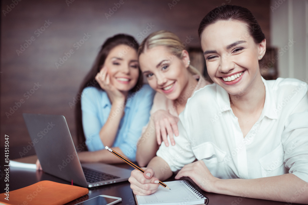 portrait of cheerful businesswomen working on new business idea portrait of cheerful businesswomen working on new business idea