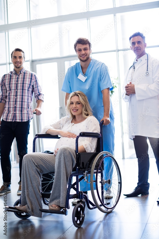 Portrait of doctor carrying pregnant woman in a Portrait of doctor carrying pregnant woman in a