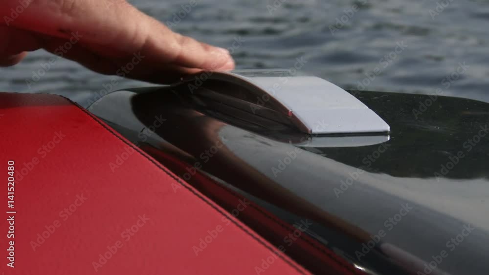 Detail of hand closing and lifting chrome handle on sporty rubber boat. Detail of hand closing and lifting chrome handle on sporty rubber boat.