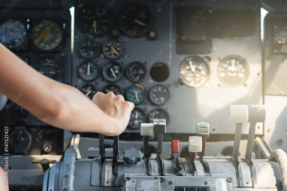 Airplane Cockpit thrust levers with female hand on top for takeoff