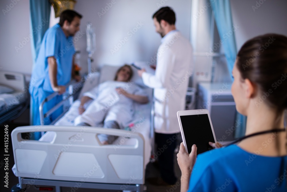 Fototapeta premium Female doctor using digital tablet in the ward