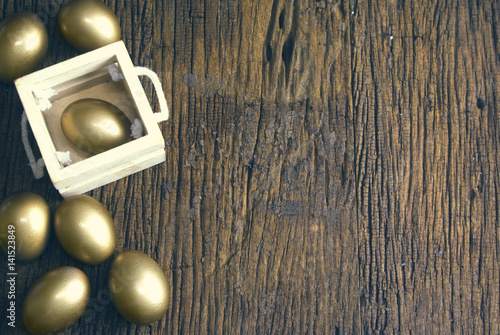 golden eggs and wooden texture with wood box