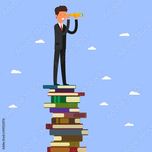 Businessman stands on stack of books.