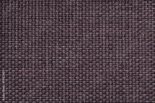 Brown background with braided checkered pattern, closeup. Texture of the weaving fabric, macro.