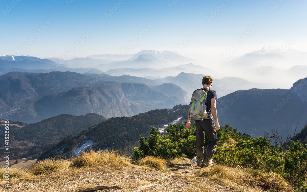 Man walking hiking on mountain trail. Great view.