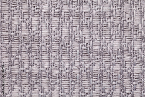 Gray knitted woolen background with a pattern of soft, fleecy cloth. Texture of textile closeup.