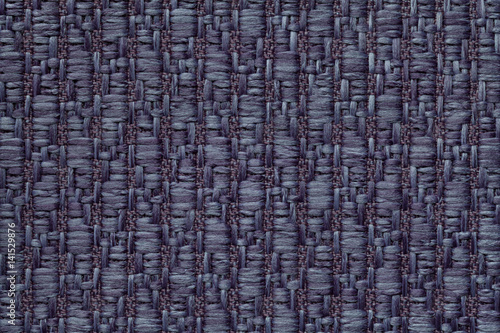 Dark blue knitted woolen background with a pattern of soft, fleecy cloth. Texture of textile closeup.
