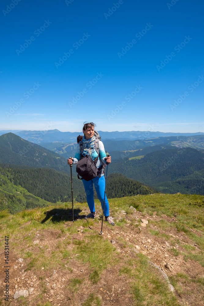 Fototapeta premium Dreaming woman, traveler with backpack relax on a top of mountain