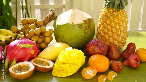 Exotic tropical fruit on table. Dolly shot. photo