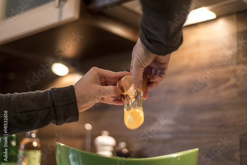 Canvas Print hands cracking an egg into bowl to make fresh waffles